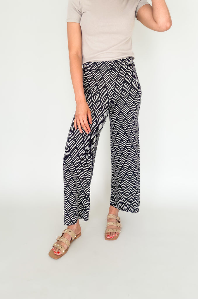 These Jacquard Wide Leg Sweater Pants are perfect for adding a stylish touch to your fall wardrobe. Featuring a fun abstract printed design and a wide leg silhouette, these pants will keep you looking and feeling chic all day long!