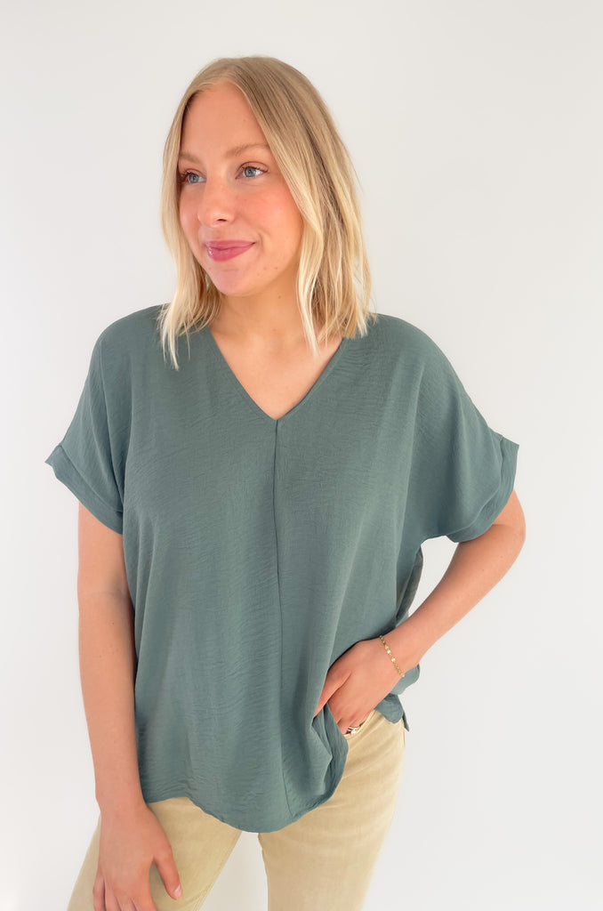 The Jamie V Neck Center Seam Blouse is a lightweight style that can be dressed up or down for any occasion! This chic v-neck top has a cuffed sleeves and a center seam design for added detail. It's a fool proof basic to always have in your closet! 