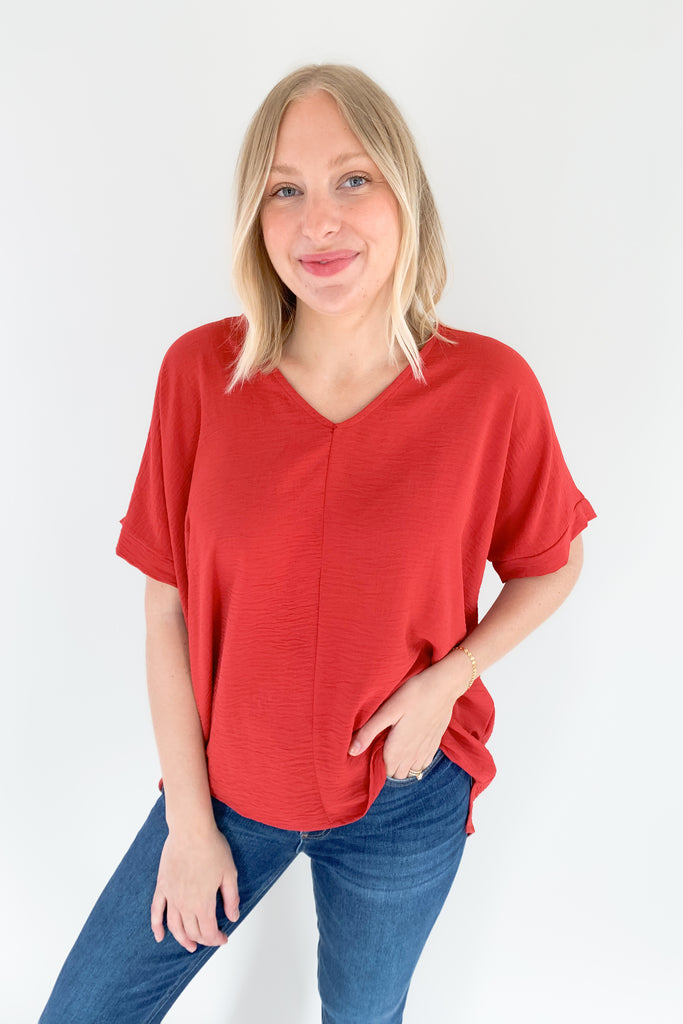 The Jamie V Neck Center Seam Blouse is a lightweight style that can be dressed up or down for any occasion! This chic v-neck top has a cuffed sleeves and a center seam design for added detail. It's a fool proof basic to always have in your closet! 