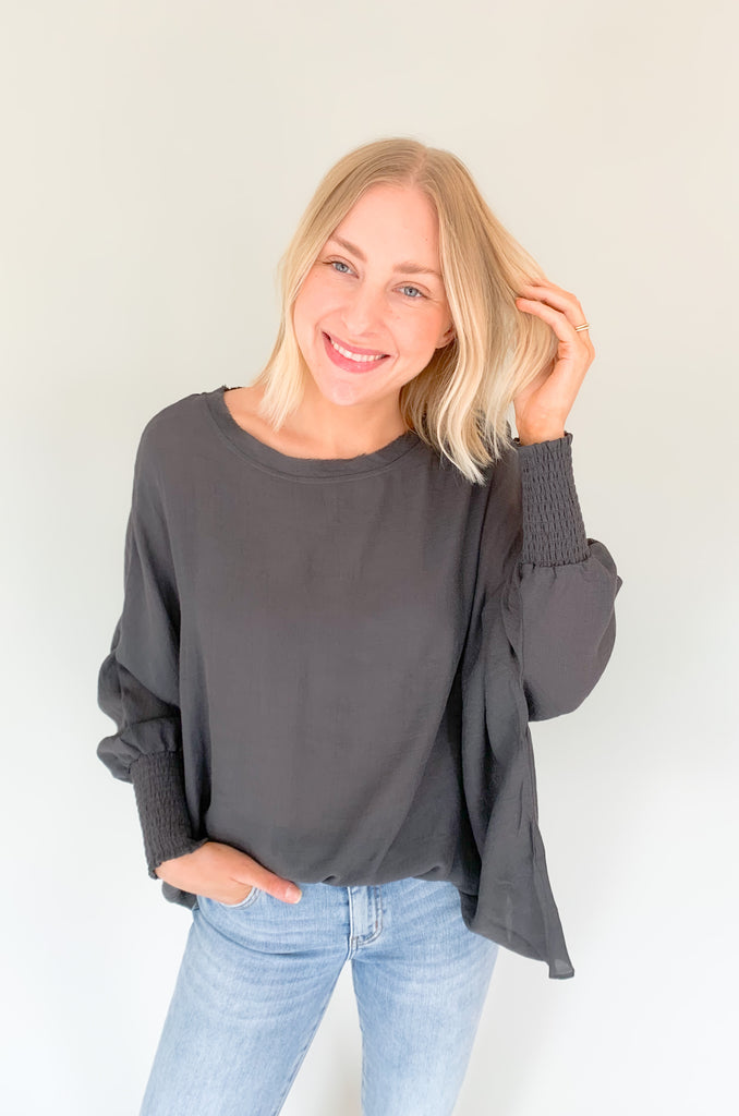 The Joel Smocked Dolman Sleeve Oversized Top is perfect for the breezy summer days. Made of a lightweight and airy fabric, it allows for a cute and comfortable fit. This top features long sleeves and a smocked wrist for an effortless, chic look. With its oversized style, it’s easy to layer or wear alone.