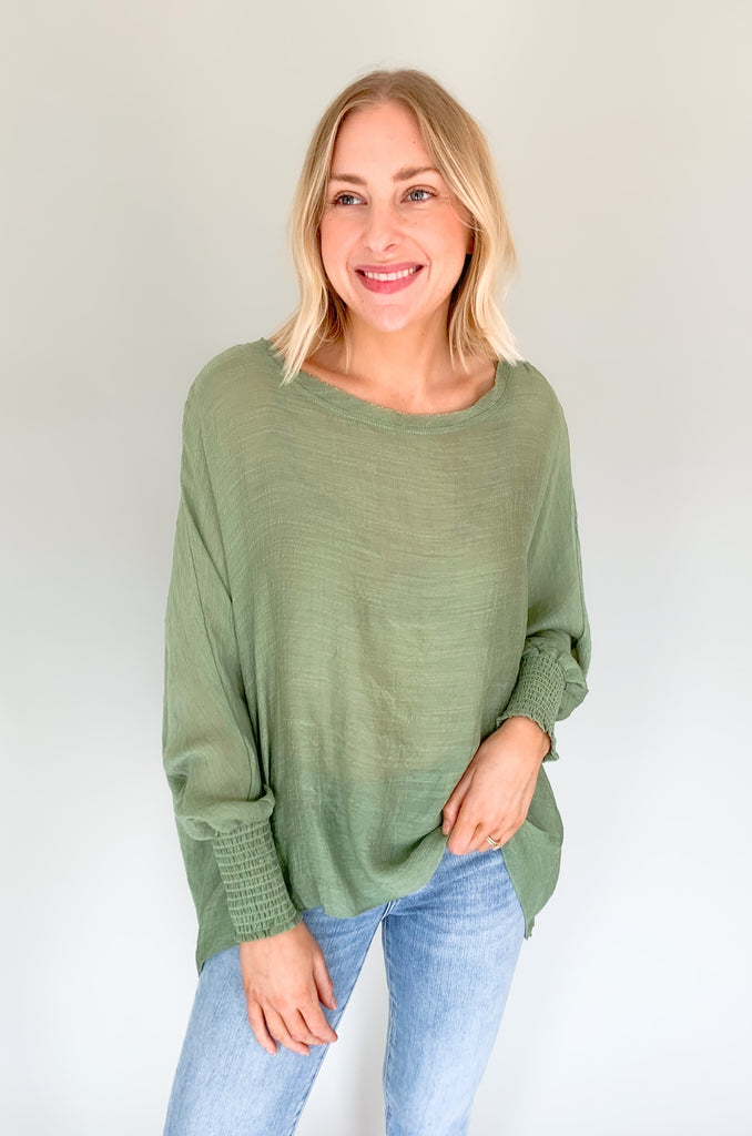 The Joel Smocked Dolman Sleeve Oversized Top is perfect for the breezy summer days. Made of a lightweight and airy fabric, it allows for a cute and comfortable fit. This top features long sleeves and a smocked wrist for an effortless, chic look. With its oversized style, it’s easy to layer or wear alone.