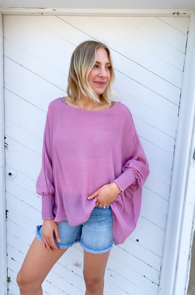 The Joel Smocked Dolman Sleeve Oversized Top is perfect for the breezy summer days. Made of a lightweight and airy fabric, it allows for a cute and comfortable fit. This top features long sleeves and a smocked wrist for an effortless, chic look. With its oversized style, it’s easy to layer or wear alone.