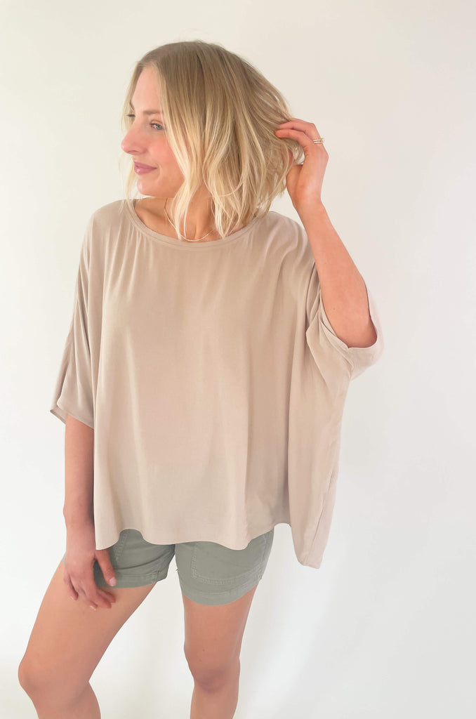 Introducing the Johnna Solid Oversized Top that's here to keep you lookin' cool and feeling comfortable all summer! This lightweight round neck boxy top is airy and effortless, but can easily be dressed up for any occassion. Choose between steel blue or sand for an amazing everyday look. 