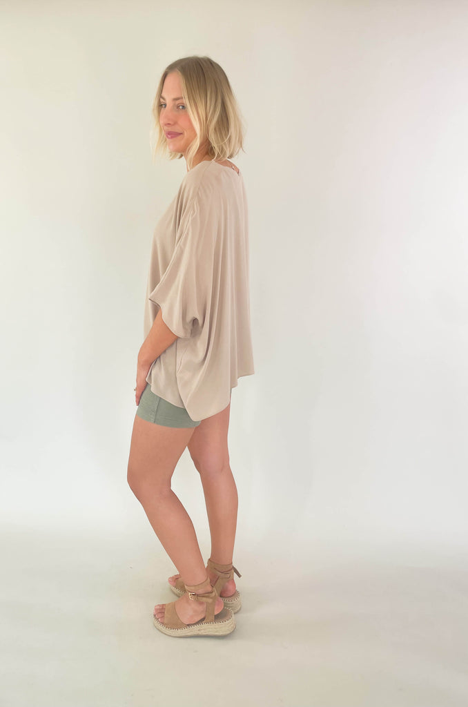 Introducing the Johnna Solid Oversized Top that's here to keep you lookin' cool and feeling comfortable all summer! This lightweight round neck boxy top is airy and effortless, but can easily be dressed up for any occassion. Choose between steel blue or sand for an amazing everyday look. 