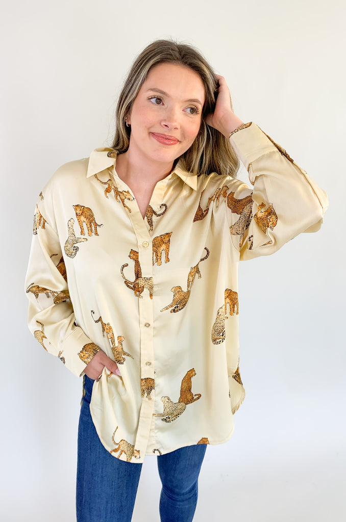 natural colored button up blouse with collar, featuring a unique leopard design.