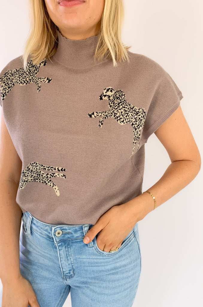 Look stylish in the Leopards Walking Mock Neck Cropped Sleeveless Top! This comfortable top features a cropped and sleeveless design with a mock neckline for a sleek, put-together look. Plus, the trendy boxy look, similar to a sweater vest is right on trend. You could eaven layer it over a long sleeve tee in the winter time. 