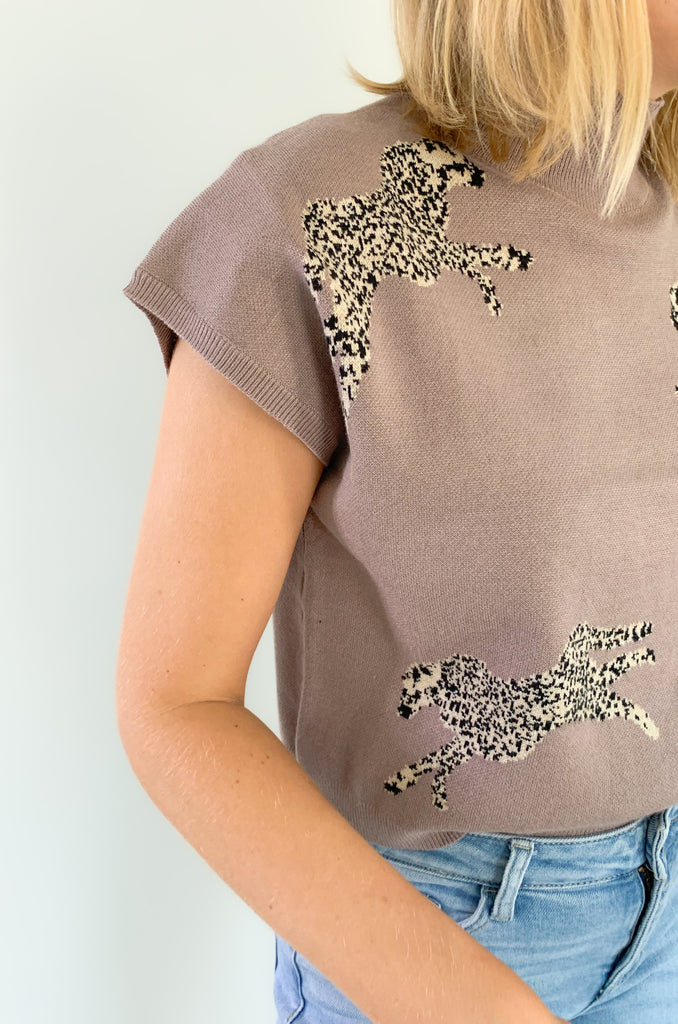 Look stylish in the Leopards Walking Mock Neck Cropped Sleeveless Top! This comfortable top features a cropped and sleeveless design with a mock neckline for a sleek, put-together look. Plus, the trendy boxy look, similar to a sweater vest is right on trend. You could eaven layer it over a long sleeve tee in the winter time. 