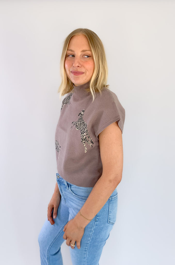 Look stylish in the Leopards Walking Mock Neck Cropped Sleeveless Top! This comfortable top features a cropped and sleeveless design with a mock neckline for a sleek, put-together look. Plus, the trendy boxy look, similar to a sweater vest is right on trend. You could eaven layer it over a long sleeve tee in the winter time. 
