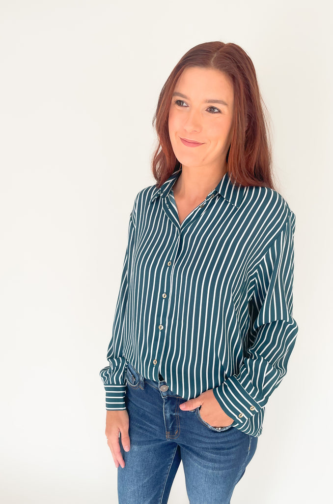 lightweight, semi sheer striped blouse with collared details and gold buttons. Available in pin striped black or hunter green