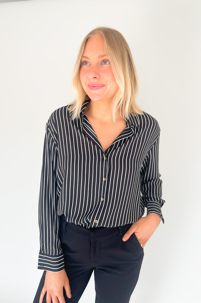 lightweight, semi sheer striped blouse with collared details and gold buttons. Available in pin striped black or hunter green
