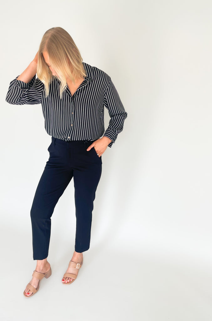 lightweight, semi sheer striped blouse with collared details and gold buttons. Available in pin striped black or hunter green