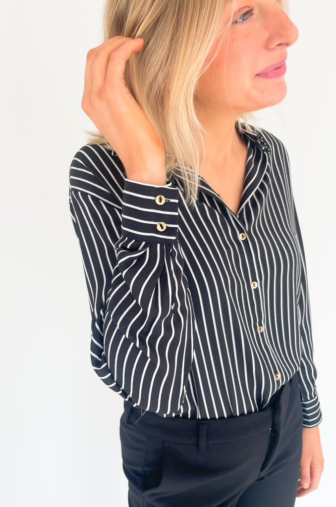 lightweight, semi sheer striped blouse with collared details and gold buttons. Available in pin striped black or hunter green