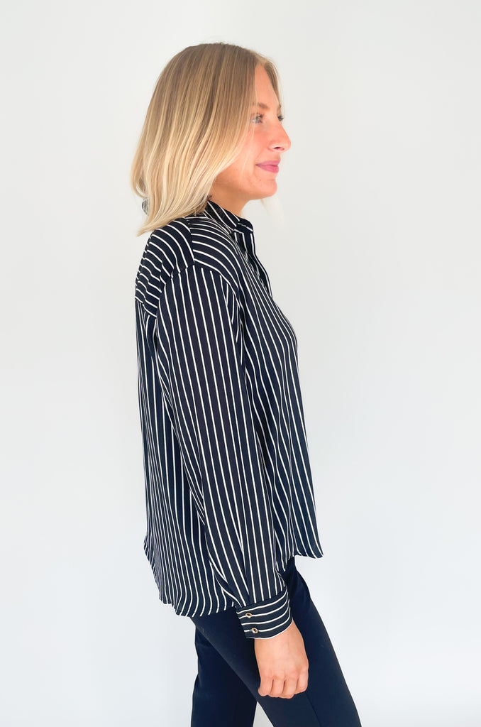 lightweight, semi sheer striped blouse with collared details and gold buttons. Available in pin striped black or hunter green