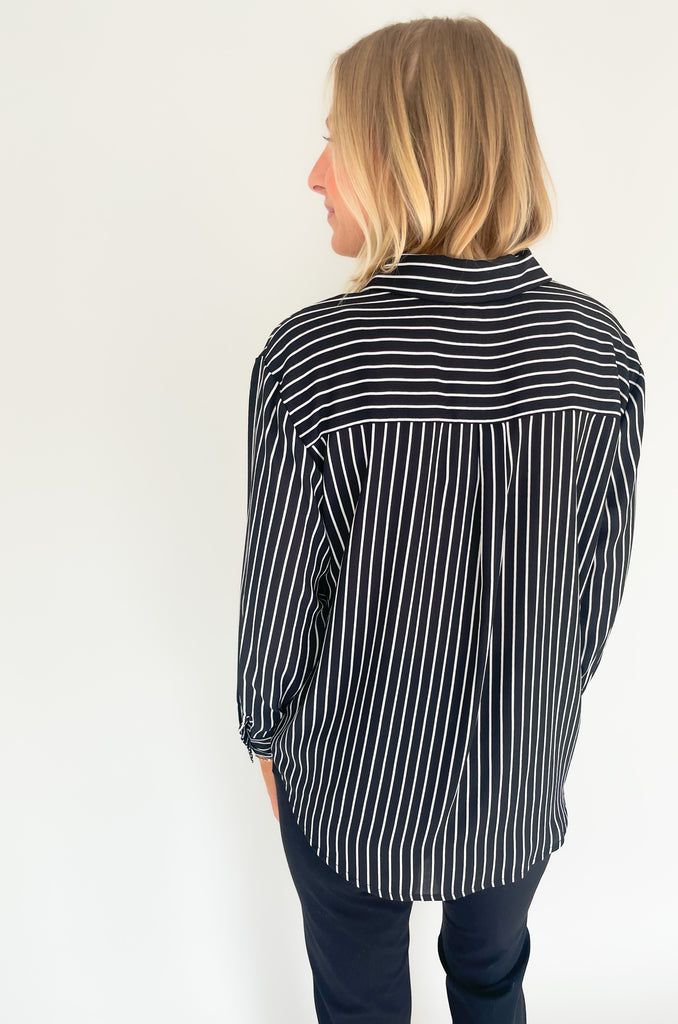 lightweight, semi sheer striped blouse with collared details and gold buttons. Available in pin striped black or hunter green