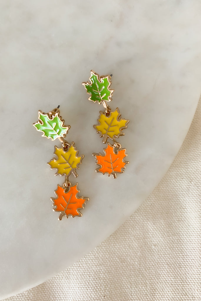 The Linked Enamel Leaf Waterfall Post Earrings are perfect for fall! They are cute and playful way to get into the new season spirit. These dangle leaves are metal with a mix of colored enamel. They are comfortable and have a post backing.