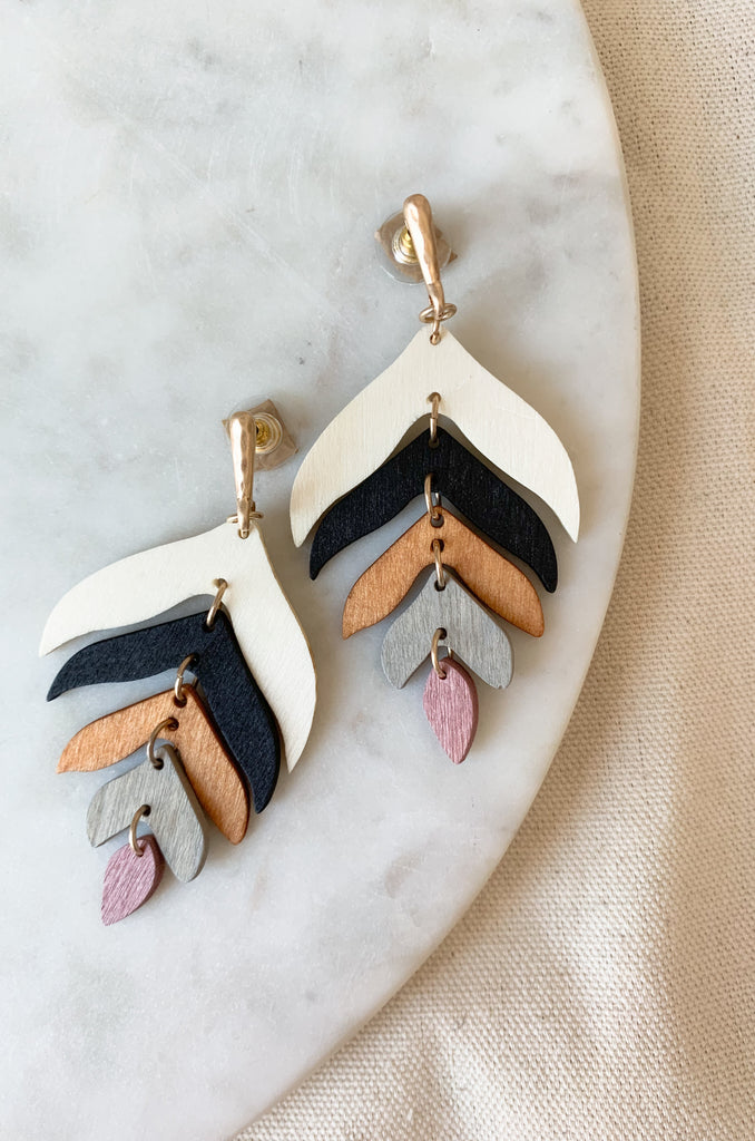These Linked Wooden Leaf Drop Earrings feature multi-colored wood leaves for a unique, stylish look. Lightweight and comfortable, they are the perfect way to add a touch of fun to your everyday look! Plus, the colors really speak to fall. 