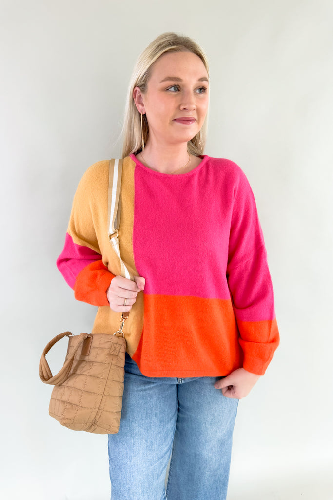 Experience the perfect blend of warmth and style with the Liz Orange + Pink Block Sweater! Featuring hints of yellow and neon orange in a lightweight soft fabric, it's a stunner for any fashion forward wardrobe. Plus the bold color is so on trend, you cannot  go wrong with this one. 