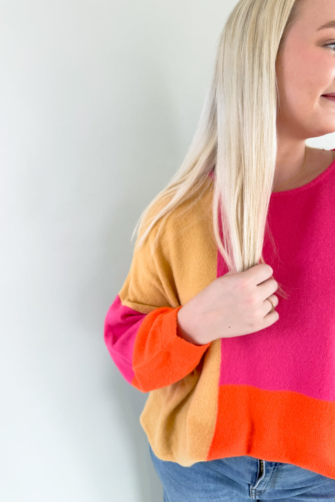 Experience the perfect blend of warmth and style with the Liz Orange + Pink Block Sweater! Featuring hints of yellow and neon orange in a lightweight soft fabric, it's a stunner for any fashion forward wardrobe. Plus the bold color is so on trend, you cannot  go wrong with this one. 