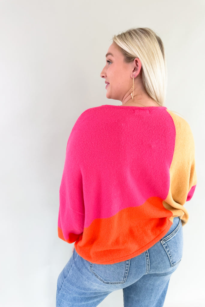 Experience the perfect blend of warmth and style with the Liz Orange + Pink Block Sweater! Featuring hints of yellow and neon orange in a lightweight soft fabric, it's a stunner for any fashion forward wardrobe. Plus the bold color is so on trend, you cannot  go wrong with this one. 