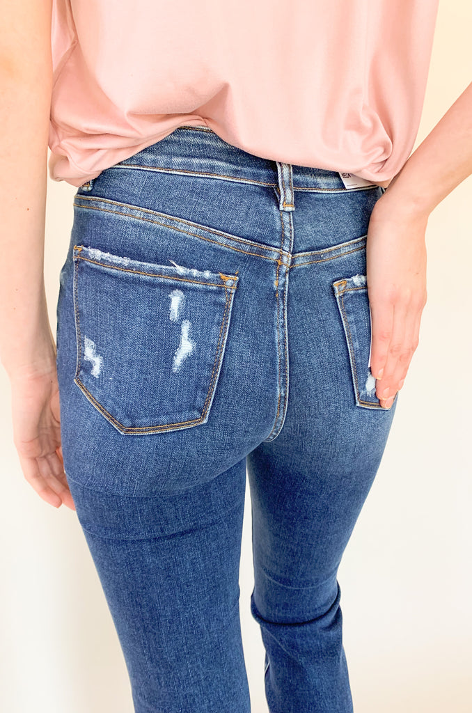 Light wash mid rise straight leg jeans with slight distressing around the pockets. 