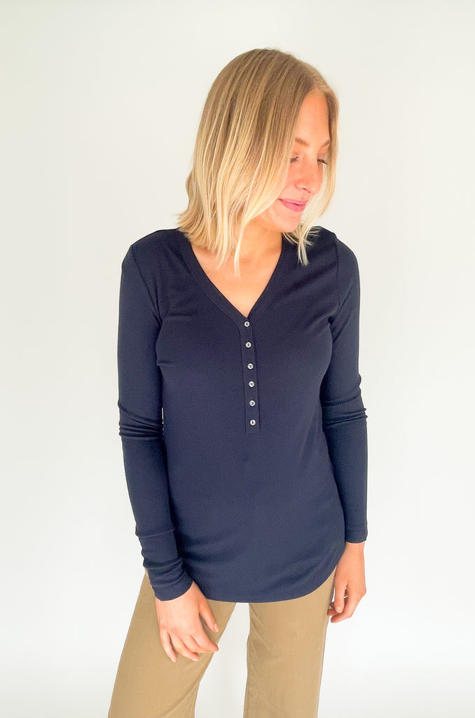 This Liverpool Los Angeles Long Sleeve Henley Rib Knit Top is perfect for creating a layered look, or can be worn by itself. Featuring buttons, a v-neck and long sleeves, this is a timeless piece. It's ultra soft and elevated too. Crafted from rib knit fabric for a snug fit, this top can be effortlessly dressed up or down! Choose between dark navy and cream.