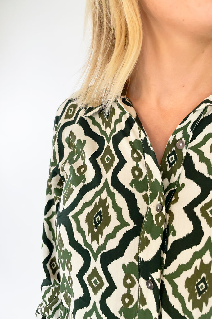 The Macy Olive Printed Midi Dress is the perfect way to elevate your wardrobe! This stylish piece has a button-up top with collared details and long sleeves, plus a tiered body for a flattering shape. It reads very boho chic. 