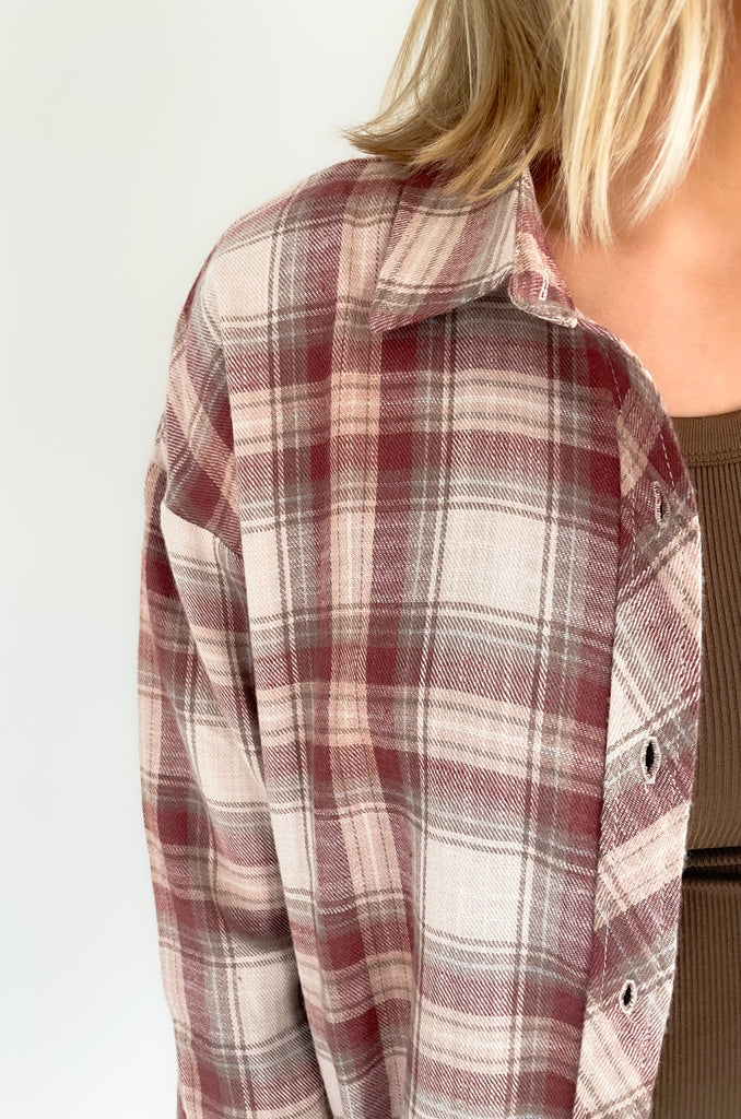 button down single breast pocket flannel with marroon and brown print. Slightly oversized fit