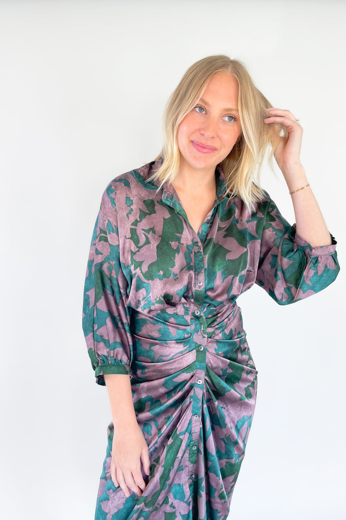 Make a statement in the Meadow Abstract Print Ruched Midi Dress! Designed with eye-catching hunter green and purple hues, plus a beautiful floral print, this midi length dress is a showstopper. It features a collared detail, 3/4 balloon sleeves, a high-low silhouette, and ruching around the waist for an unforgettable look.