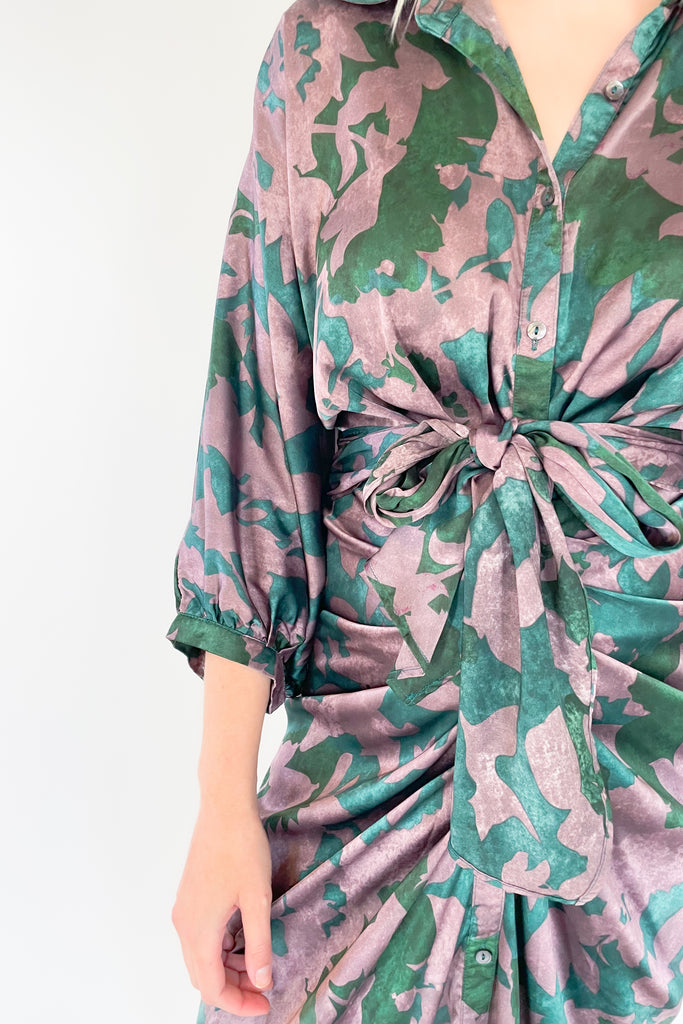 Make a statement in the Meadow Abstract Print Ruched Midi Dress! Designed with eye-catching hunter green and purple hues, plus a beautiful floral print, this midi length dress is a showstopper. It features a collared detail, 3/4 balloon sleeves, a high-low silhouette, and ruching around the waist for an unforgettable look.