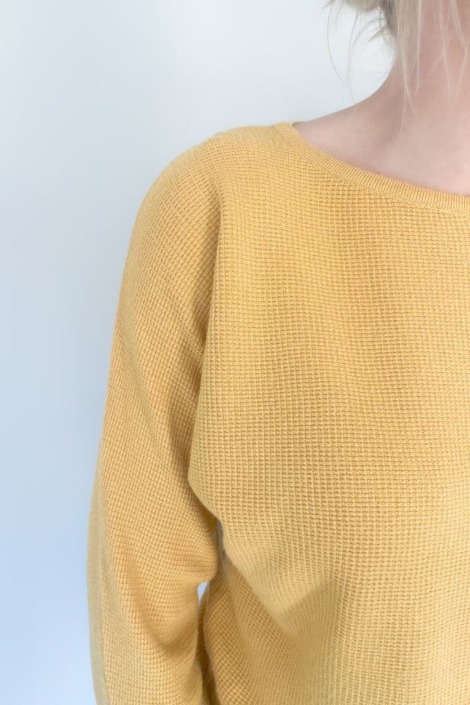 This Mustard Boat Neck Ribbed Sweater is perfect for any season! Made from an ultra soft, stretchy and lightweight fabric with a waffle texture for extra coziness, this sweater will quickly become your favorite go-to piece. 
