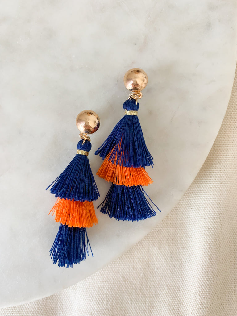 Stand out during game day with our Navy & Orange Tassel Earrings. Crafted with gold balls, these earrings are the perfect finishing touch to any outfit. The orange and navy is perfect for any Bears fan or University of Illinois. 