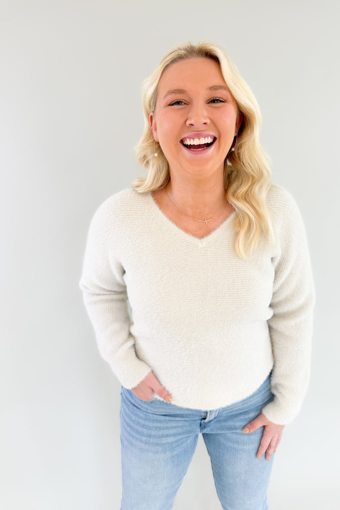 Try on the Noel Fuzzy Ivory Lurex Sweater for a look that's cozy yet chic. Its v neckline and slightly oversized body make it ultra comfortable, and the golden lurex accents add just the right touch of style. This cozy sweater is holiday approved!
