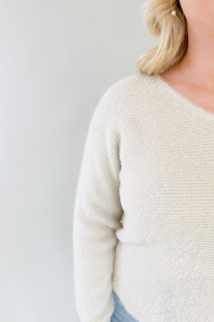 Try on the Noel Fuzzy Ivory Lurex Sweater for a look that's cozy yet chic. Its v neckline and slightly oversized body make it ultra comfortable, and the golden lurex accents add just the right touch of style. This cozy sweater is holiday approved!
