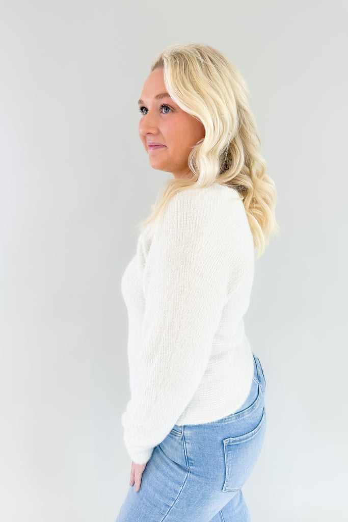 Try on the Noel Fuzzy Ivory Lurex Sweater for a look that's cozy yet chic. Its v neckline and slightly oversized body make it ultra comfortable, and the golden lurex accents add just the right touch of style. This cozy sweater is holiday approved!