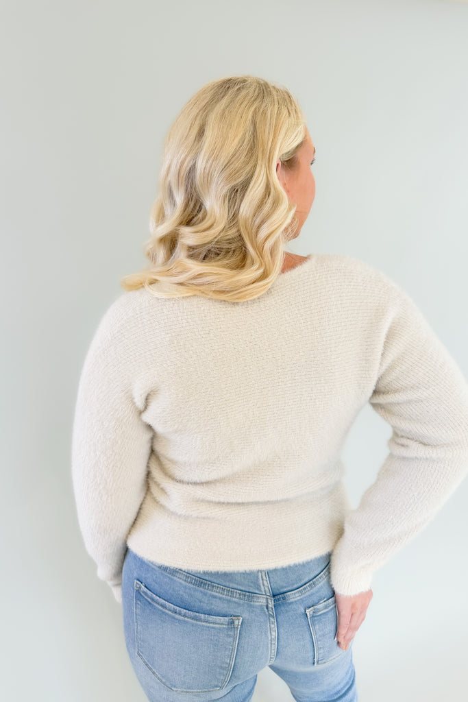 Try on the Noel Fuzzy Ivory Lurex Sweater for a look that's cozy yet chic. Its v neckline and slightly oversized body make it ultra comfortable, and the golden lurex accents add just the right touch of style. This cozy sweater is holiday approved!