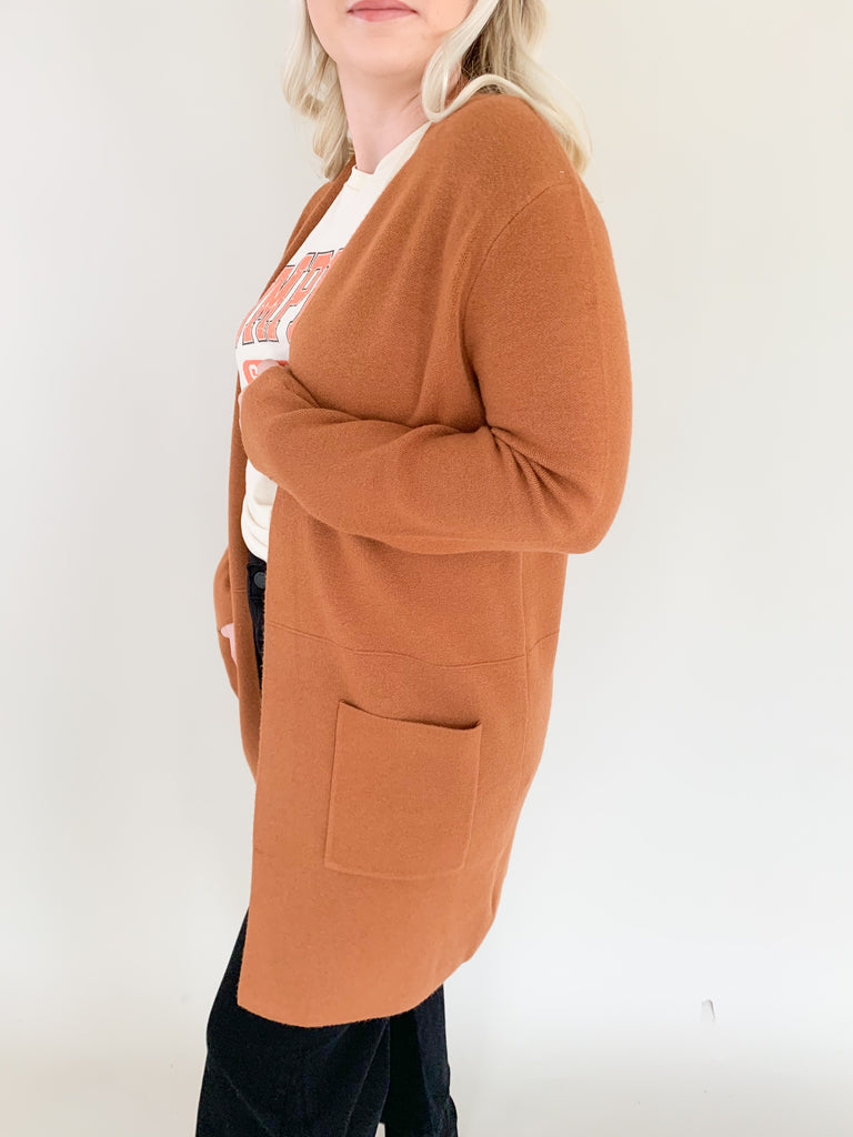 Long open front cardigan in copper brown with side pockets and soft fabric 