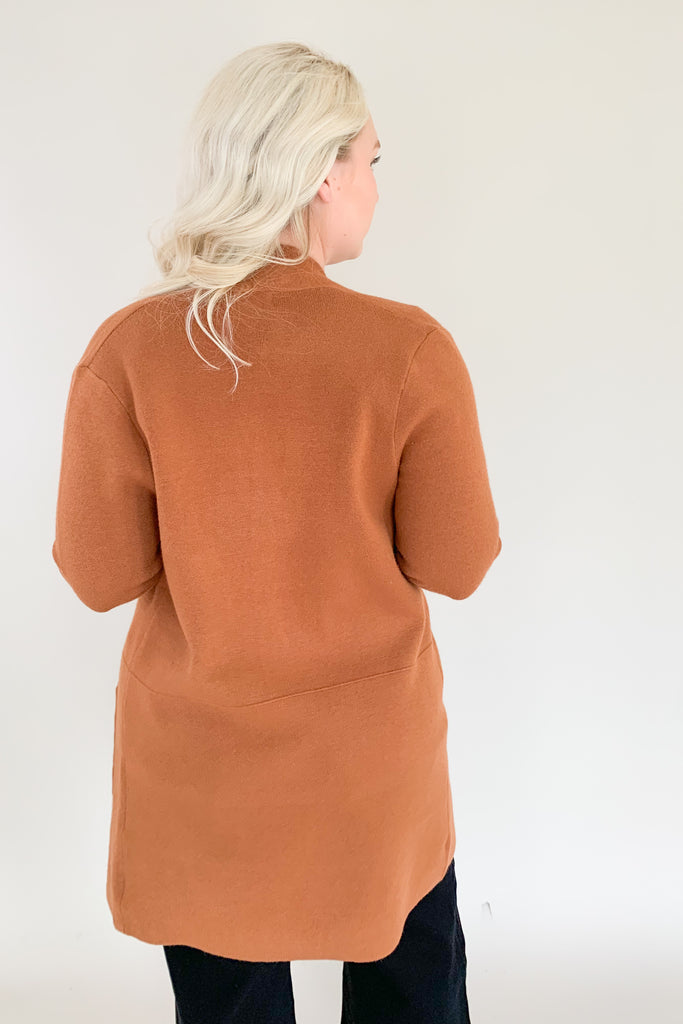 Long open front cardigan in copper brown with side pockets and soft fabric 