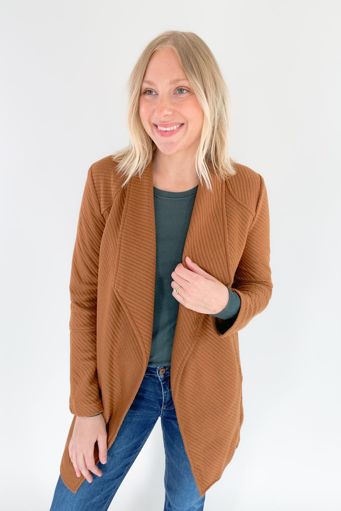 The Oaklynn Open Front Long Cardigan is elevated, chic, and timeless. You can easily dress it up or down for any event, making it such a versatile piece. The fabric is soft and stretchy too. There is a unique chevron stitching all over the cardigan for detail. We cannot say enough good things about this style- it's a must have! 