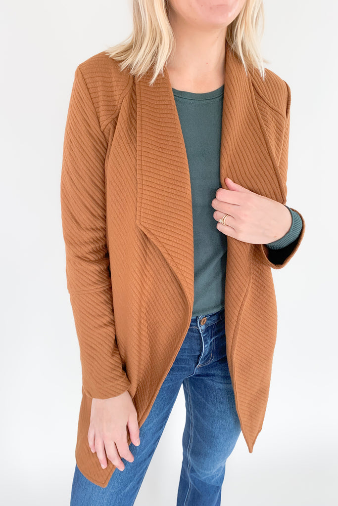 The Oaklynn Open Front Long Cardigan is elevated, chic, and timeless. You can easily dress it up or down for any event, making it such a versatile piece. The fabric is soft and stretchy too. There is a unique chevron stitching all over the cardigan for detail. We cannot say enough good things about this style- it's a must have! 