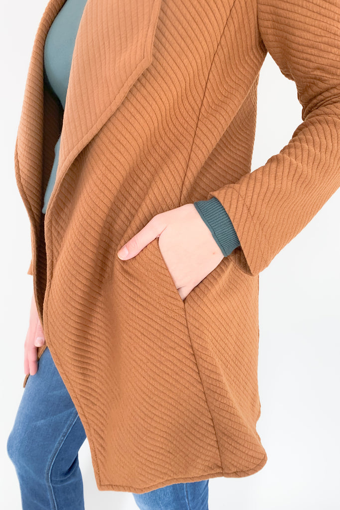The Oaklynn Open Front Long Cardigan is elevated, chic, and timeless. You can easily dress it up or down for any event, making it such a versatile piece. The fabric is soft and stretchy too. There is a unique chevron stitching all over the cardigan for detail. We cannot say enough good things about this style- it's a must have! 