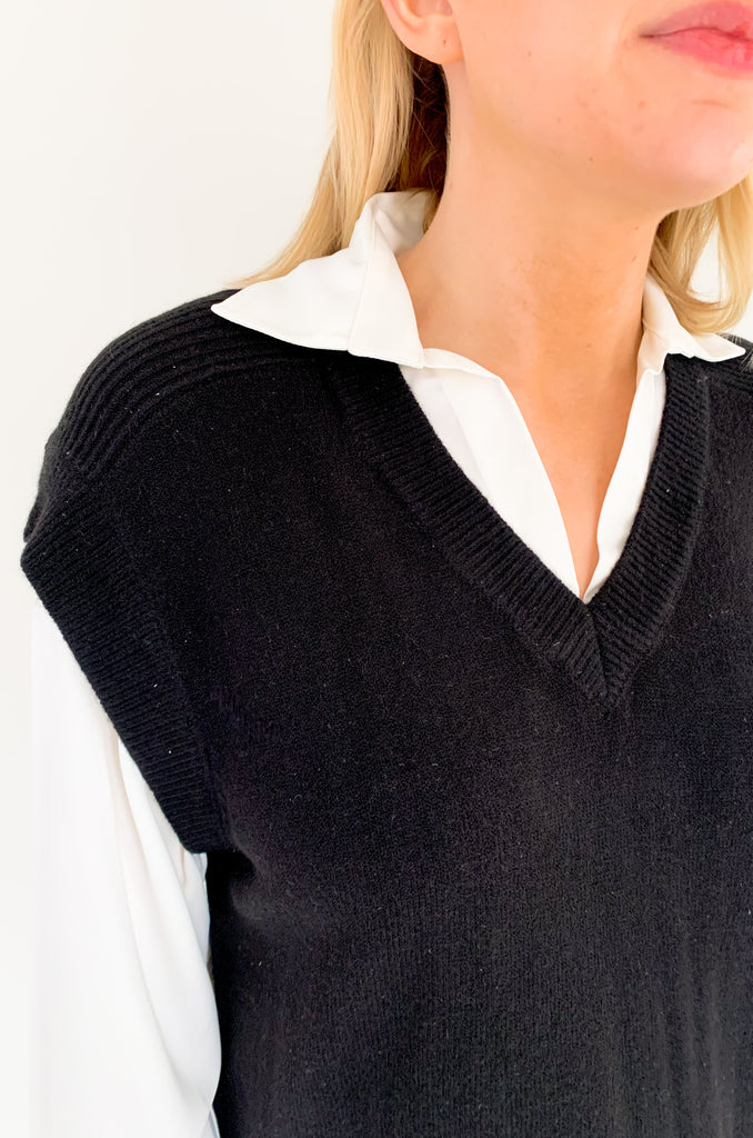 Stay stylish when the weather cools down with the Elan Geist Black Sweater Vest & Layered Blouse! This unique one-piece is made of knit fabric to keep you warm and comfortable, while featuring a flattering satin blouse underneath.