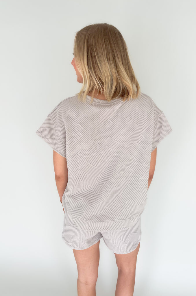 elastic waist drawstring textured short. Pairs back to matching set and available in several colors
