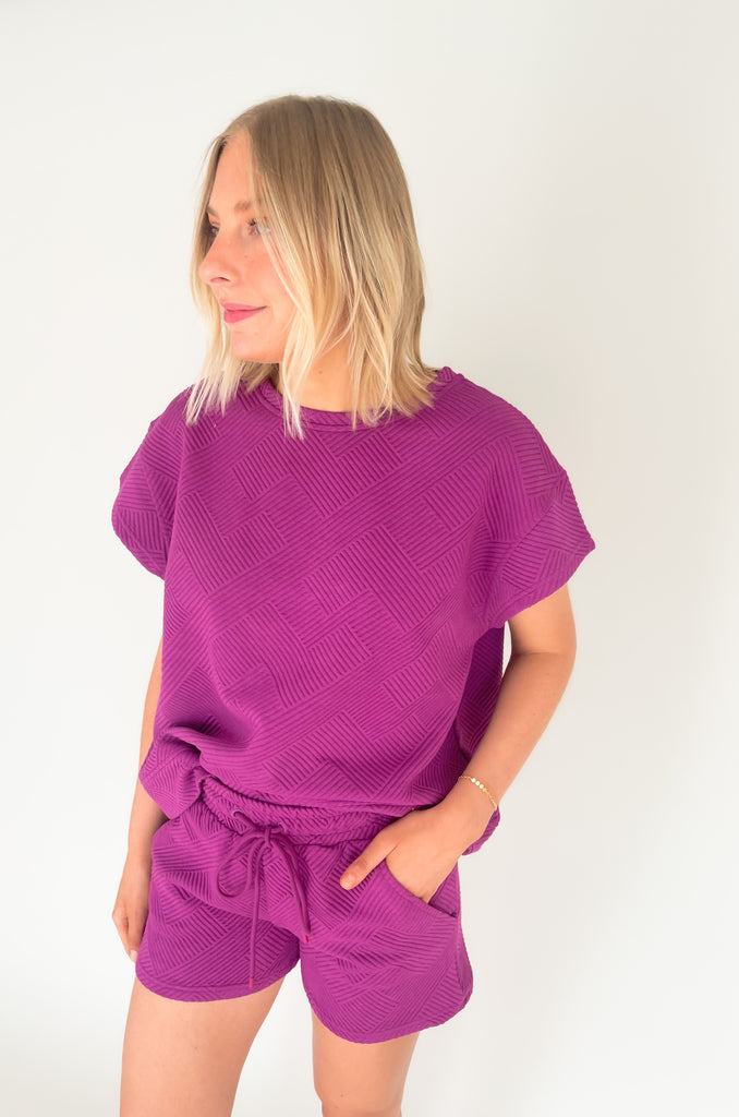 elastic waist drawstring textured short. Pairs back to matching set and available in several colors