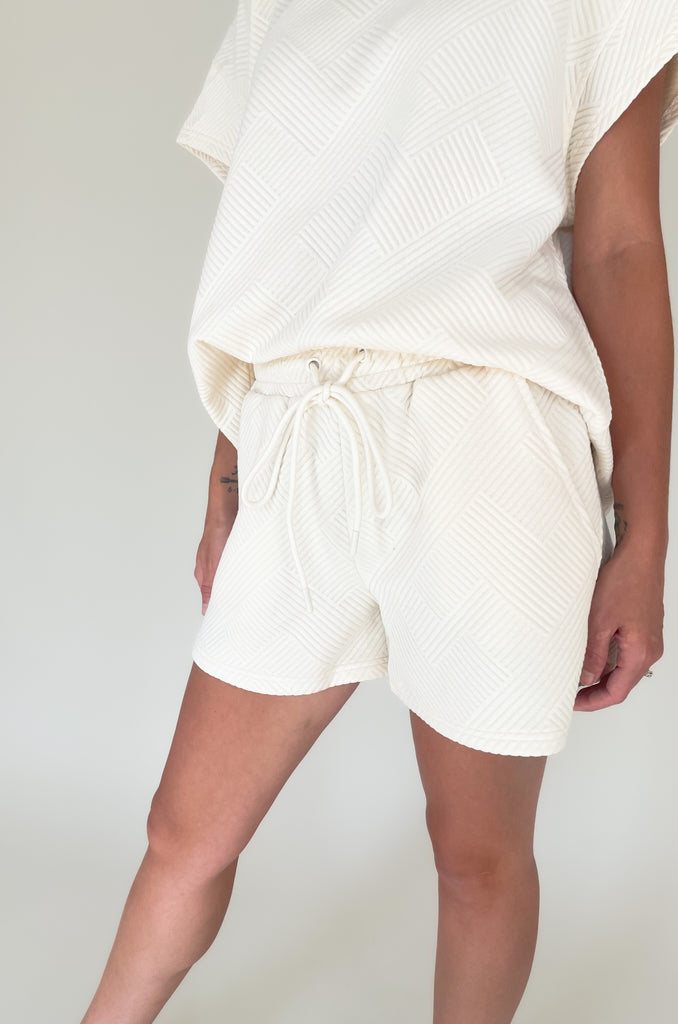 elastic waist drawstring textured short. Pairs back to matching set and available in several colors