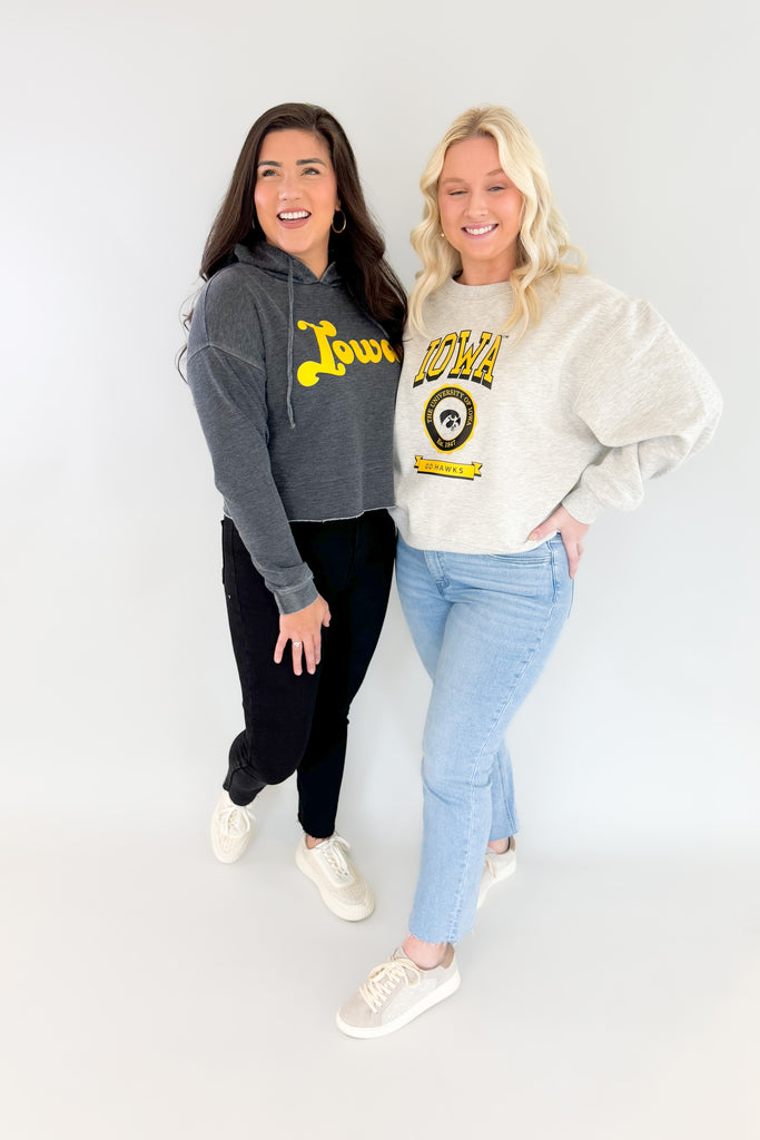 Stay cozy and cool  with this Iowa Groovy Raw Edge Hoodie! The soft fleece interior and 70s-inspired Iowa text combine a fun, vintage look. Semi-cropped with long sleeves, this hoody is perfect for any Hawkeye.