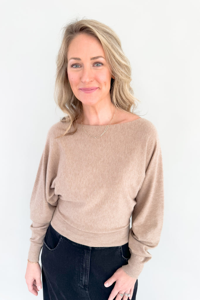 This stylish mocha sweater is perfect for any occasion, with its boat-neck design and cropped luxe fit. Enjoy the simple sophistication of this timeless look.