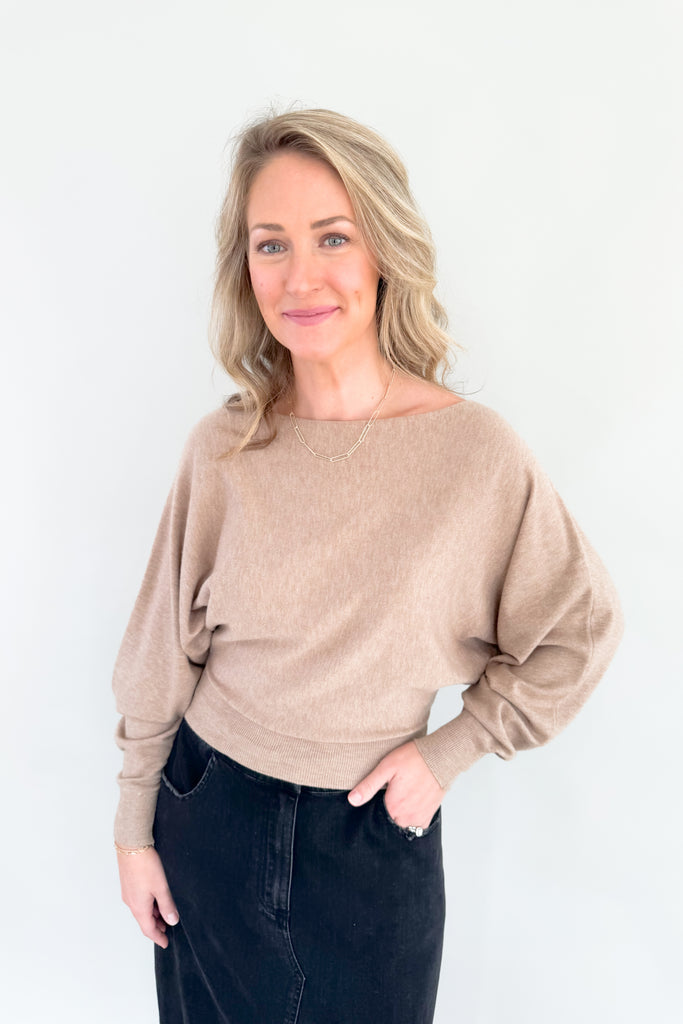 This stylish mocha sweater is perfect for any occasion, with its boat-neck design and cropped luxe fit. Enjoy the simple sophistication of this timeless look.