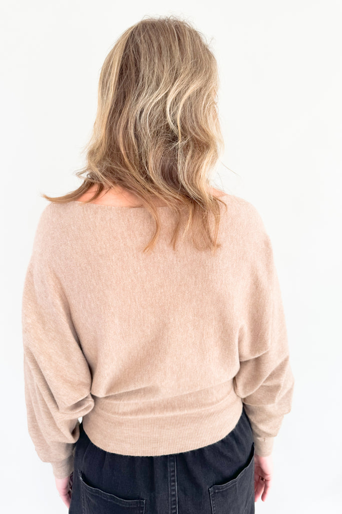 This stylish mocha sweater is perfect for any occasion, with its boat-neck design and cropped luxe fit. Enjoy the simple sophistication of this timeless look.