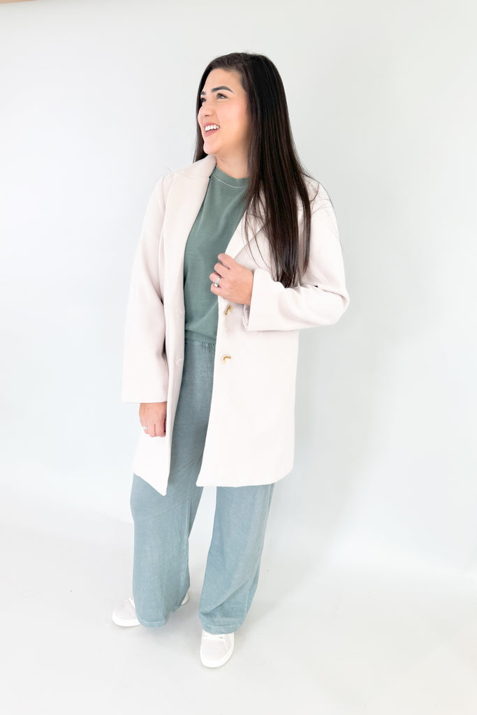 Make an elevated and cool statement with Becca's Beige Double Button Coat! This timeless, medium-weight coat is perfect for any season from fall-spring with its neutral color. It's soft and cozy, while polishing up any look! 