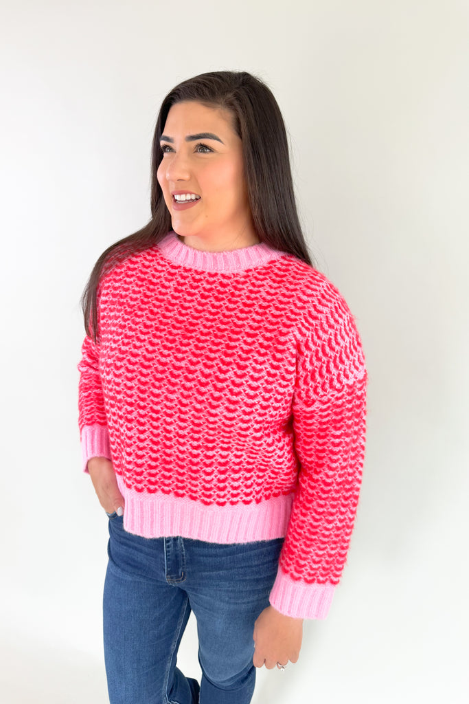Stay warm and stylish in this eye-catching Pink & Red Cropped Sweater. Red and pink yarns are woven together, creating a distinctive design that'll brighten any look. Perfect for keeping cozy and making a statement this holiday season. Plus this style is extremely comfortable and cozy too. 